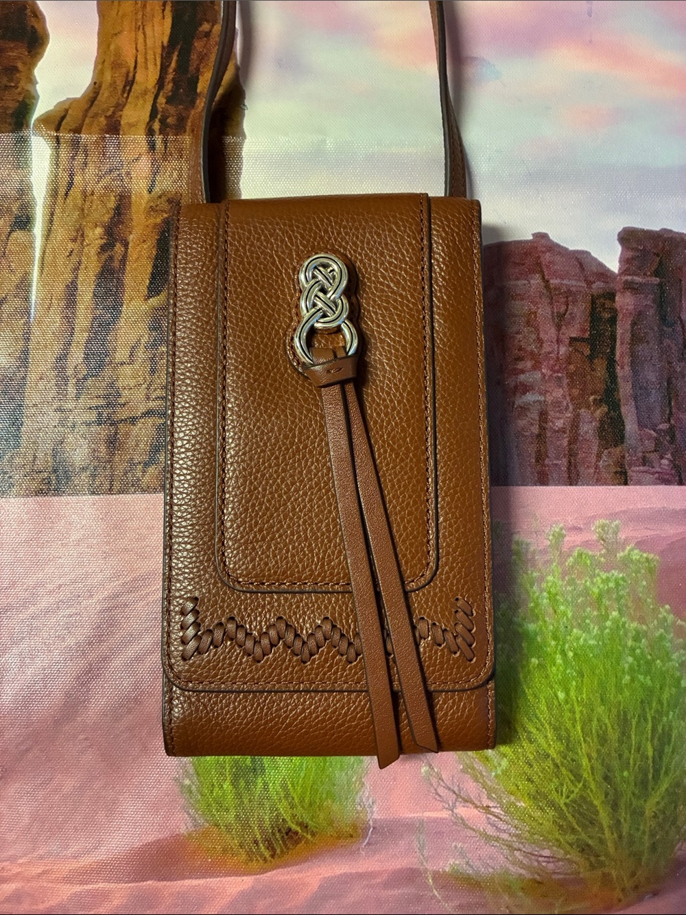 Brighton Brown Leather Crossbody Phone Bag with Tassel and Knot Accent.